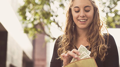 Image of a woman taking foreign currency out of her purse