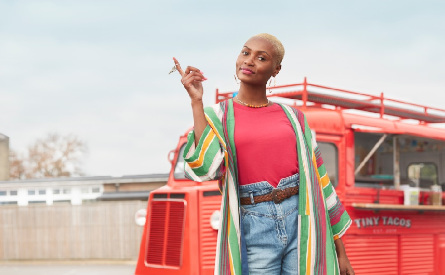 Photo of a woman holding keys to a taco van