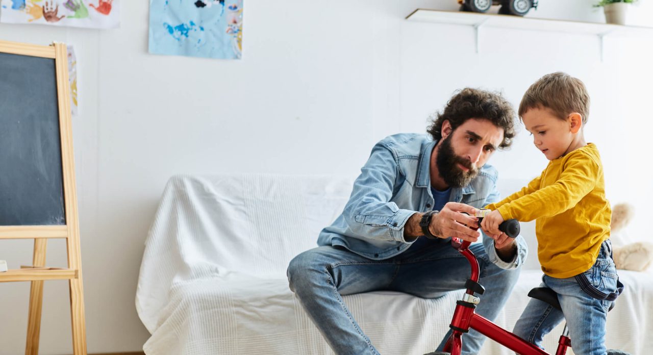 Father helping son with new bike 